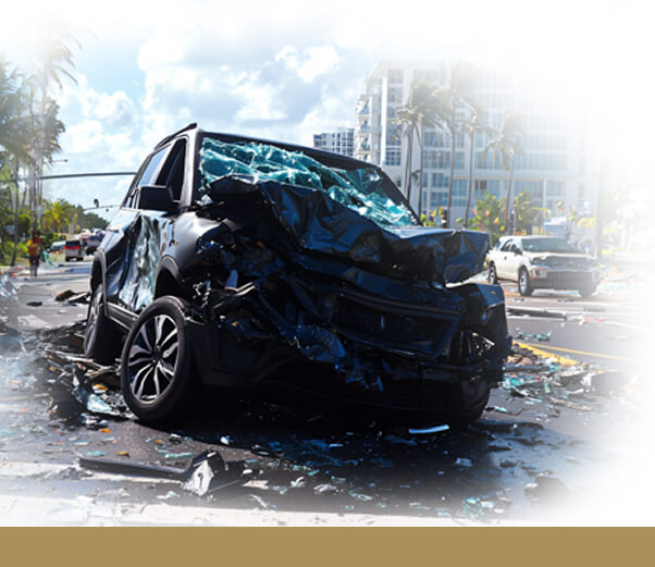 A black car with severe front-end damage after a St. Petersburg car accident