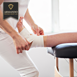 Medical professional wrapping bandages around the injured ankle of a personal injury victim in Hillsborough County