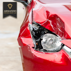 Close-up of a red car with a smashed headlight and severe front-end damage from a car crash in Town 'n' Country