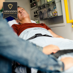 An injured man lying on a stretcher inside an ambulance receiving emergency medical care after an accident
