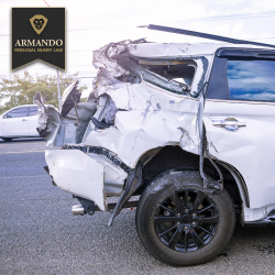 After a Largo car accident, a white car with extensive rear-end damage sits on the side of the road