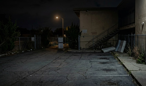 A dimly lit hotel parking lot in Tampa at night with no security to protect people on the property.