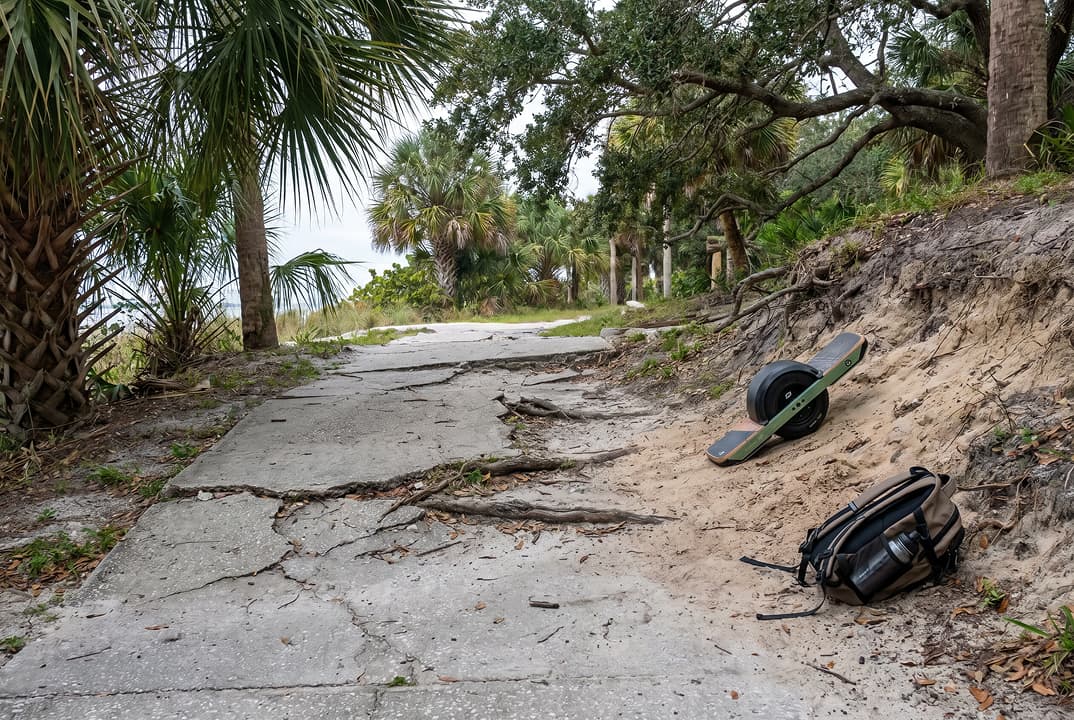 Uneven trail transition and pavement hazard on a Pinellas County multi-use route.