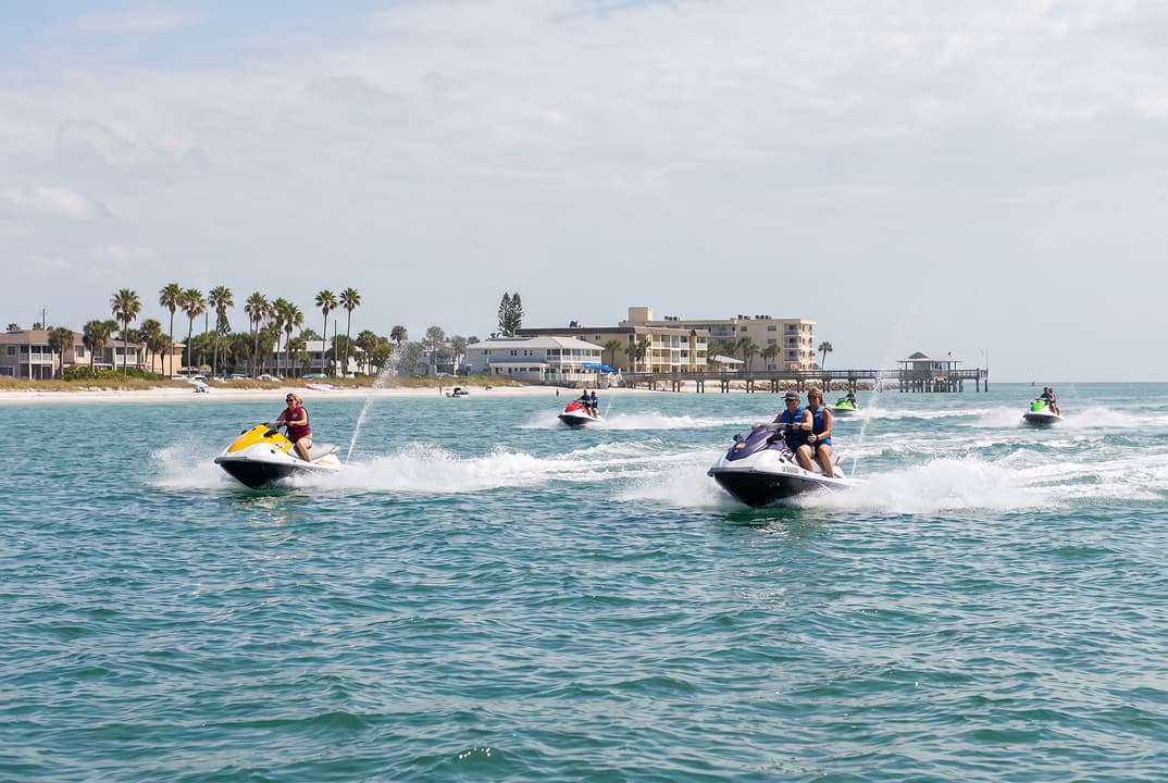 Jet ski riders on coastal water near St. Petersburg and Pinellas County beaches