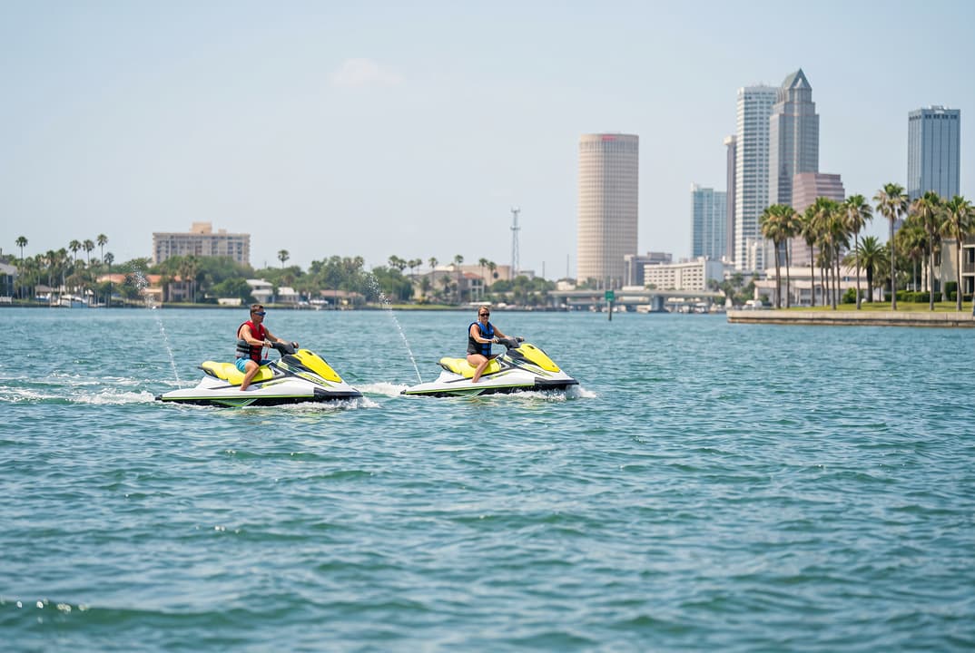 Jet ski riders on Tampa Bay water near the Tampa waterfront.